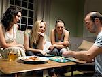 Four young people playing scrabble