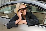 Business woman on phone in car