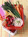 Carton of spring vegetables and dips