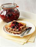 Piece of toasted bread with summer fruit jam