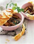 Cream of mushrooms with pinenuts and covered with pastry crust