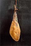 Whole raw ham hanging