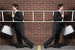 Businessman Walking with a Ladder in Two Different Directions