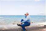 Man Looking Out to Sea With Binoculars