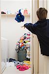 A boy throwing his laundry