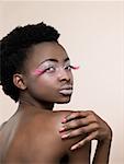 Portrait of a woman wearing pink false eyelashes