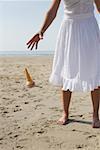 Woman dropping her ice cream on beach