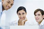 Young professionals smiling at camera, portrait