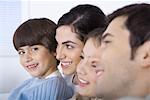 Young boy spending time with his family, smiling at camera