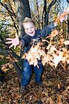 Boy Throwing Leaves