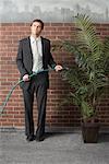 Businessman Watering Plant