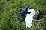 Police Officers with Woman's Body in Field, Toronto, Ontario, Canada