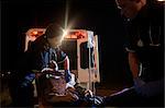 Paramedics with Injured Man by Ambulance, Toronto, Ontario, Canada