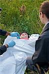 Police Officers with Woman's Body in Field, Toronto, Ontario, Canada