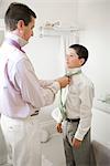 Father and Song Getting Ready for a Wedding, Father Teaching Son How to Tie a Necktie