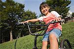Girl riding bicycle in park