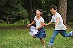 Children running in park together