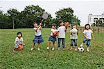 Children playing with sports equipments in a park