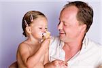 Father Watching Daughter Eat Ice Cream Cone