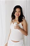 Pregnant woman holding glass of milk