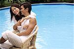 Young couple enjoying each other by the pool