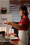 Waitress in diner serving burger