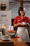 Waitress in diner holding coffee