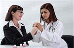 Doctor applying bandage to patient's finger