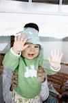 Baby Looking Through Ship Window