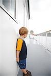 Boy Standing on Deck of Ship