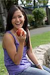 Woman Eating Nectarine, Granville Island, Vancouver, British Columbia, Canada