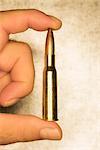 Man Holding 12.7mm Bullet