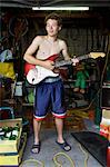 Boy in Garage with Electric Guitar