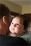 Baby Looking over Father's Shoulder