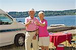 Couple toasting glasses of wine at a beach, Washington State, USA