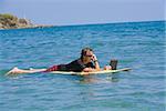 Man talking on a phone and using a laptop in the sea