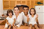 Parents with their daughters in the kitchen