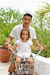 Portrait of a girl learn to ride a bicycle with her father