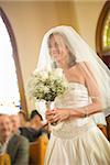 Bride holding a bouquet of flowers in a church, East Meredith, New York State, USA