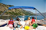 Family in a motorboat and looking at a person waterskiing, Lake Chelan, Washington State, USA