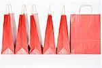 Red shopping bags in a row