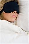 Sleeping woman wearing eye mask