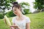 Young woman holding sweet corn