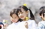 Two Japanese girls holding flowers