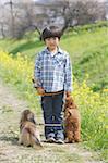 Japanese boy standing with two cute dogs