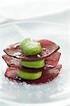 Stack of broad beans on slices of beet