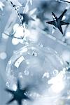 Glass Christmas ornament and star garland, close-up