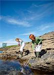 2 girls fishing in rock pool