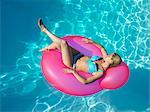 Woman on inflatable chair in pool