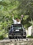 Bride and groom kissing in wedding car